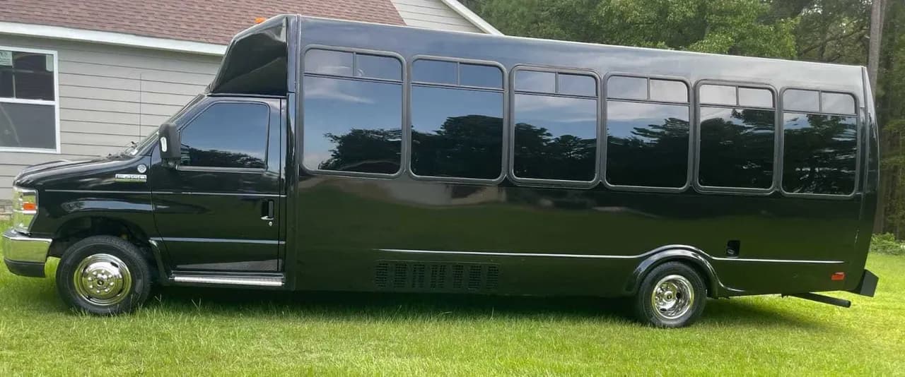 Black Ford Party Bus exterior with tinted windows for party bus rental Black Ford Party Bus exterior with tinted windows for party bus rental