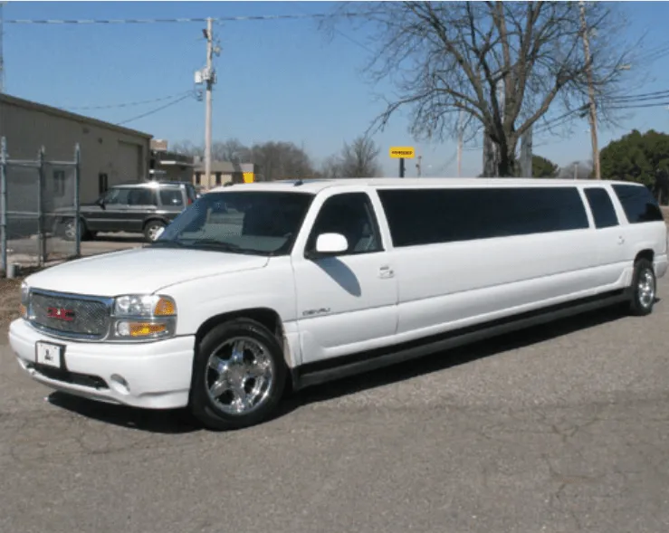 White GMC Denali Limousine exterior shot — tinted windows White GMC Denali Limousine exterior shot — tinted windows