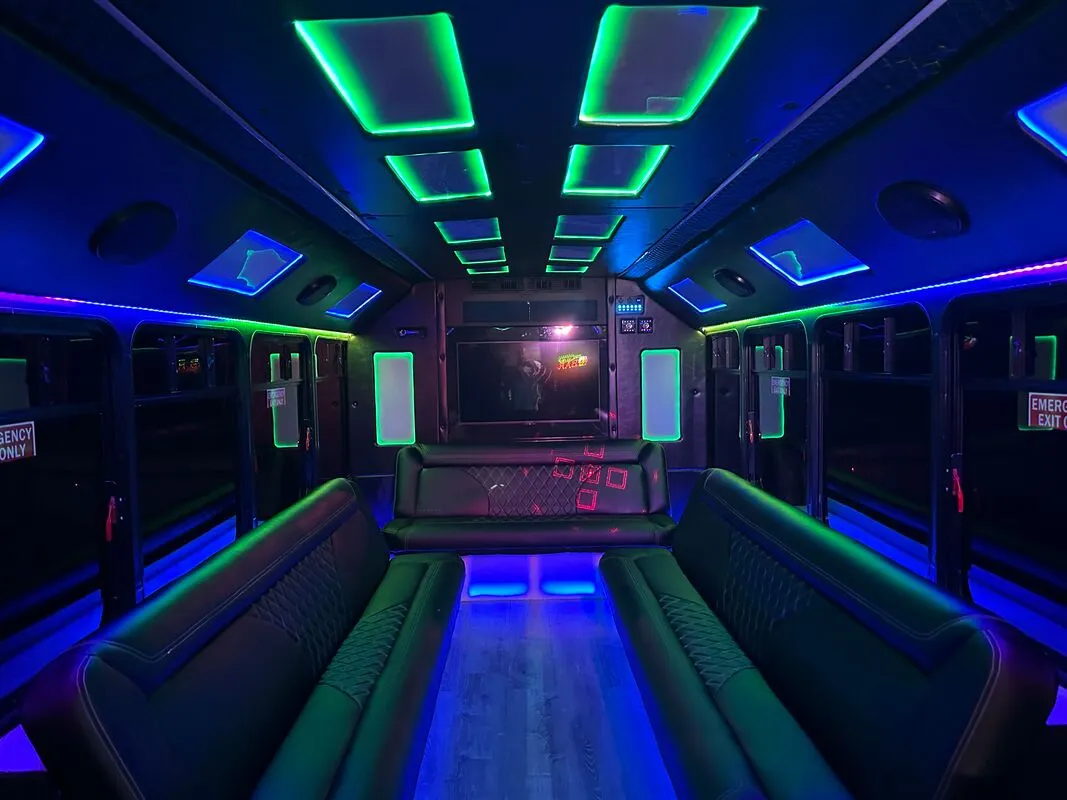 Ford E-450 Series Party BUS interior with perimeter lounge seating, LED accent lighting and LED ceiling lighting for party bus rental