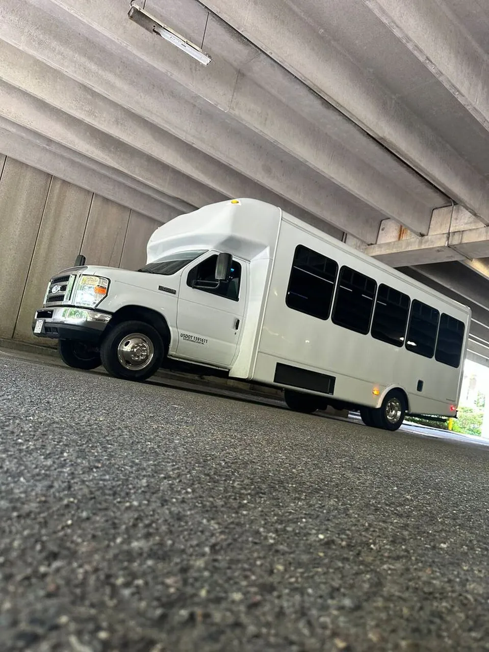 White Ford E-450 Series Party Bus exterior shot — tinted windows
