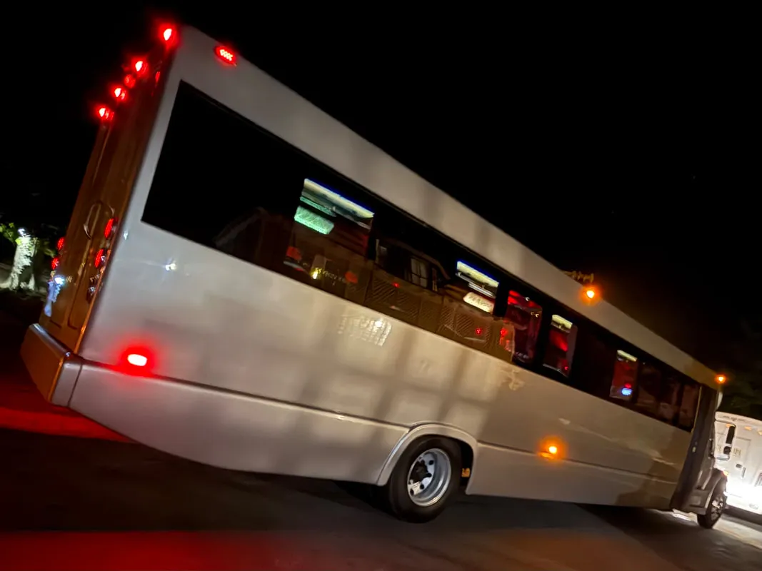 Silver Freightliner Party Bus exterior with tinted windows for party bus rental