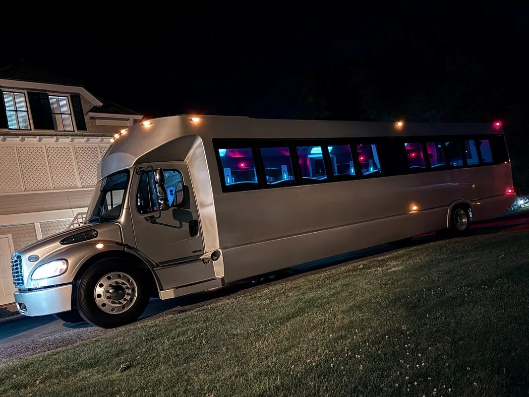 Silver Freightliner Party Bus exterior with tinted windows, photo 6 for party bus rental