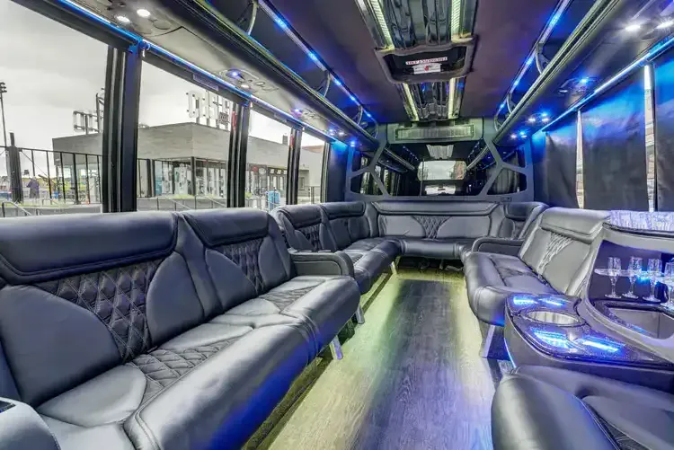 Grech Party Bus interior with perimeter lounge seating, sofa-style seating and LED accent lighting for party bus rental in Illinois