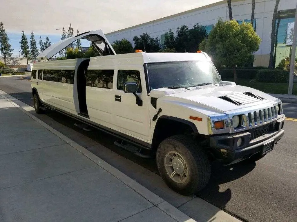 White Hummer Limo exterior with tinted windows and bridal (jet) door for limo rental in Grabill, IN