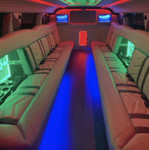 Hummer Limousine interior shot — perimeter lounge seating, LED accent lighting and TV screens