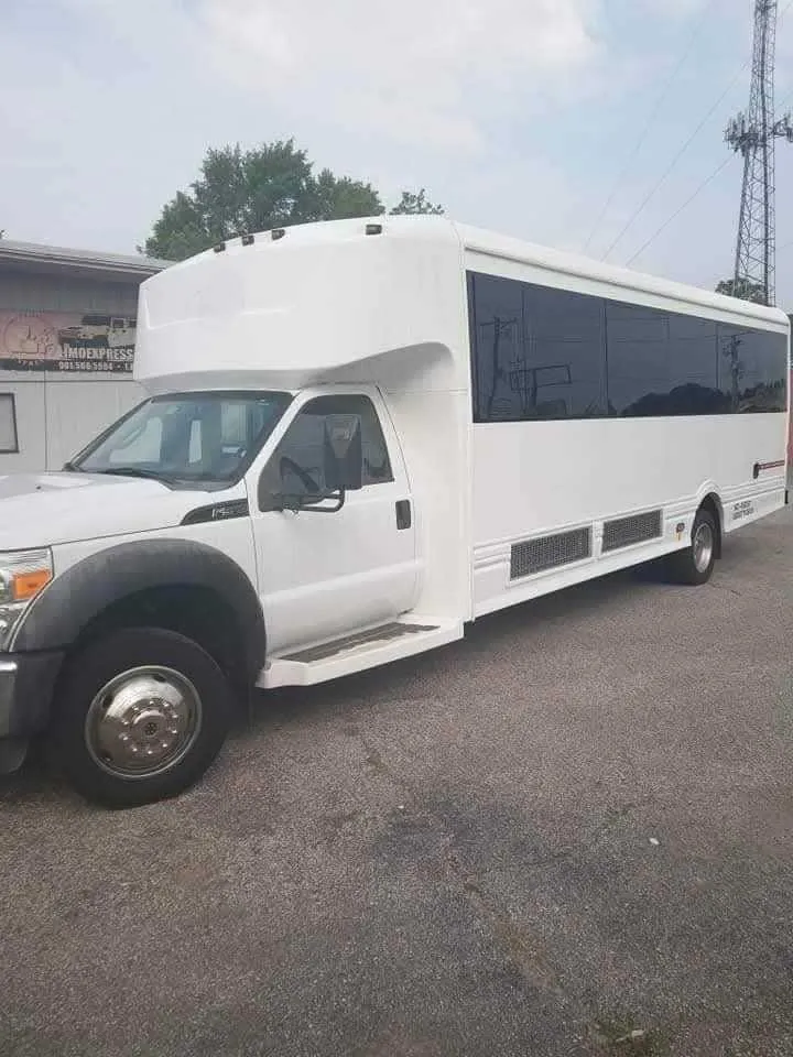Silver 32 Passenger Limo Bus exterior with tinted windows, photo 6 for party bus rental