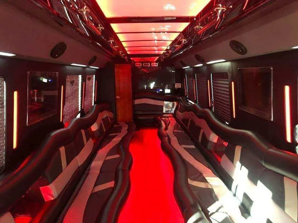 32 Passenger Limo Bus 32 Passenger Limo Bus interior with perimeter lounge seating, LED accent lighting and LED ceiling lighting for party bus rental