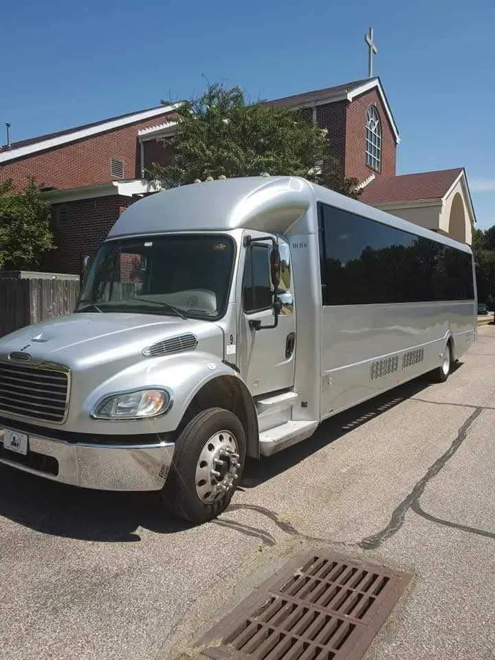 Silver 32 Passenger Limo Bus exterior with tinted windows, photo 5 for party bus rental