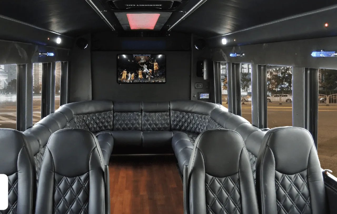 22 Passenger Limo Coach interior with perimeter lounge seating, sofa-style seating and wood-look flooring for party bus rental 22 Passenger Limo Coach interior with perimeter lounge seating, sofa-style seating and wood-look flooring for party bus rental