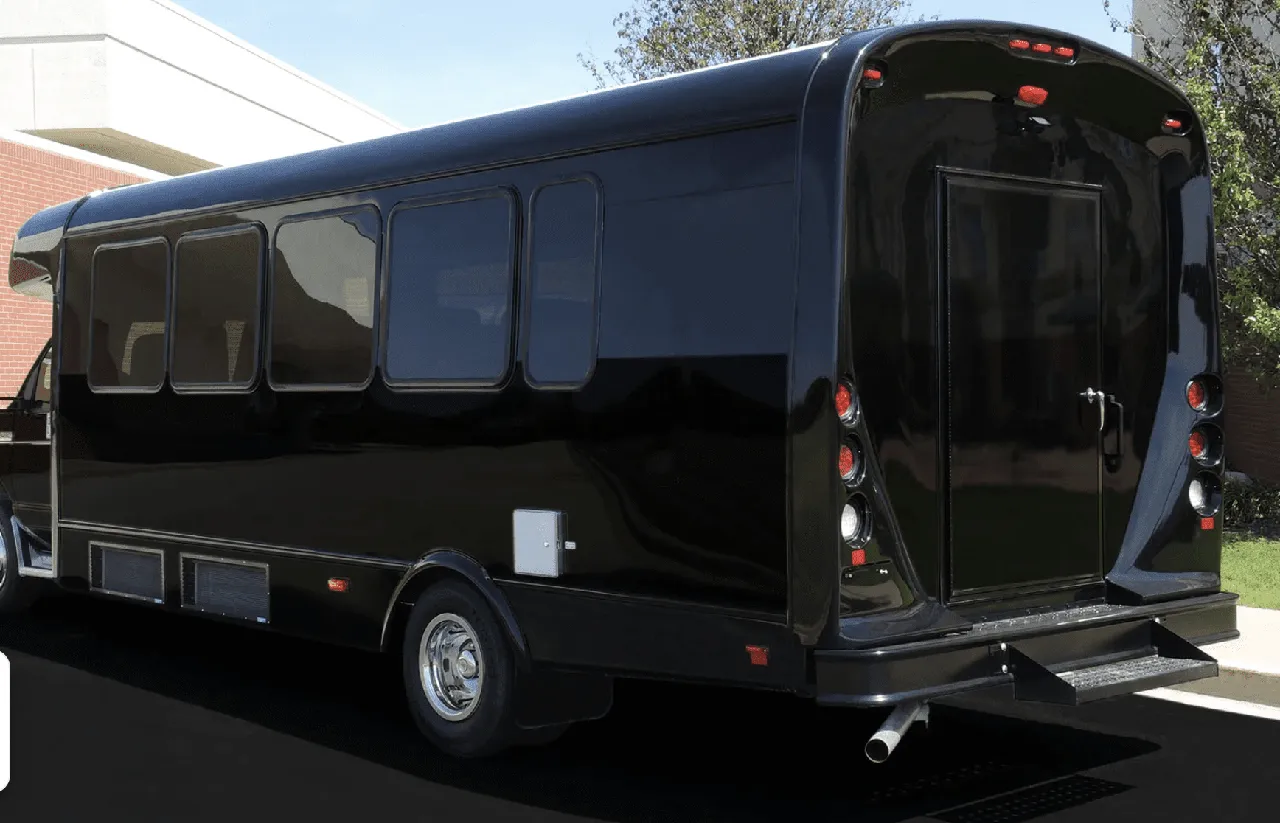 Black 22 Passenger Limo Coach exterior with tinted windows for party bus rental Black 22 Passenger Limo Coach exterior with tinted windows for party bus rental