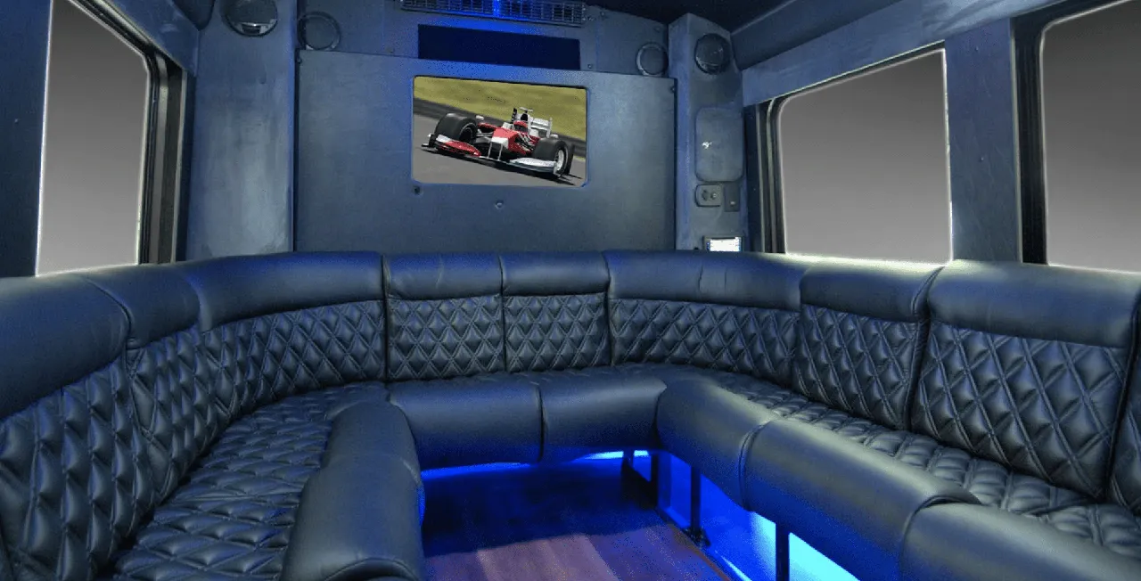22 Passenger Limo Coach interior with perimeter lounge seating, sofa-style seating and LED accent lighting for party bus rental 22 Passenger Limo Coach interior with perimeter lounge seating, sofa-style seating and LED accent lighting for party bus rental
