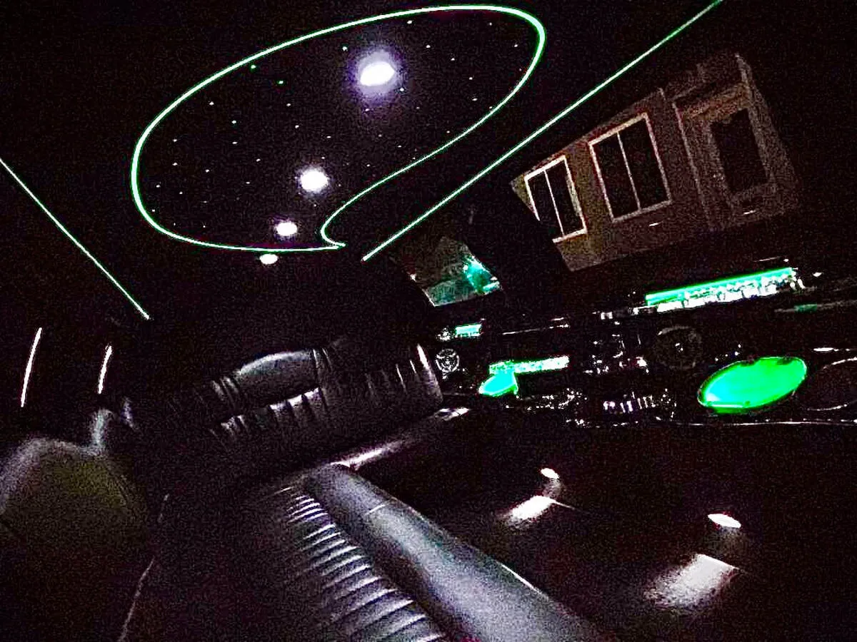 Lincoln Town CAR Limousine interior with perimeter lounge seating and starlight or fiber-optic ceiling for limo rental