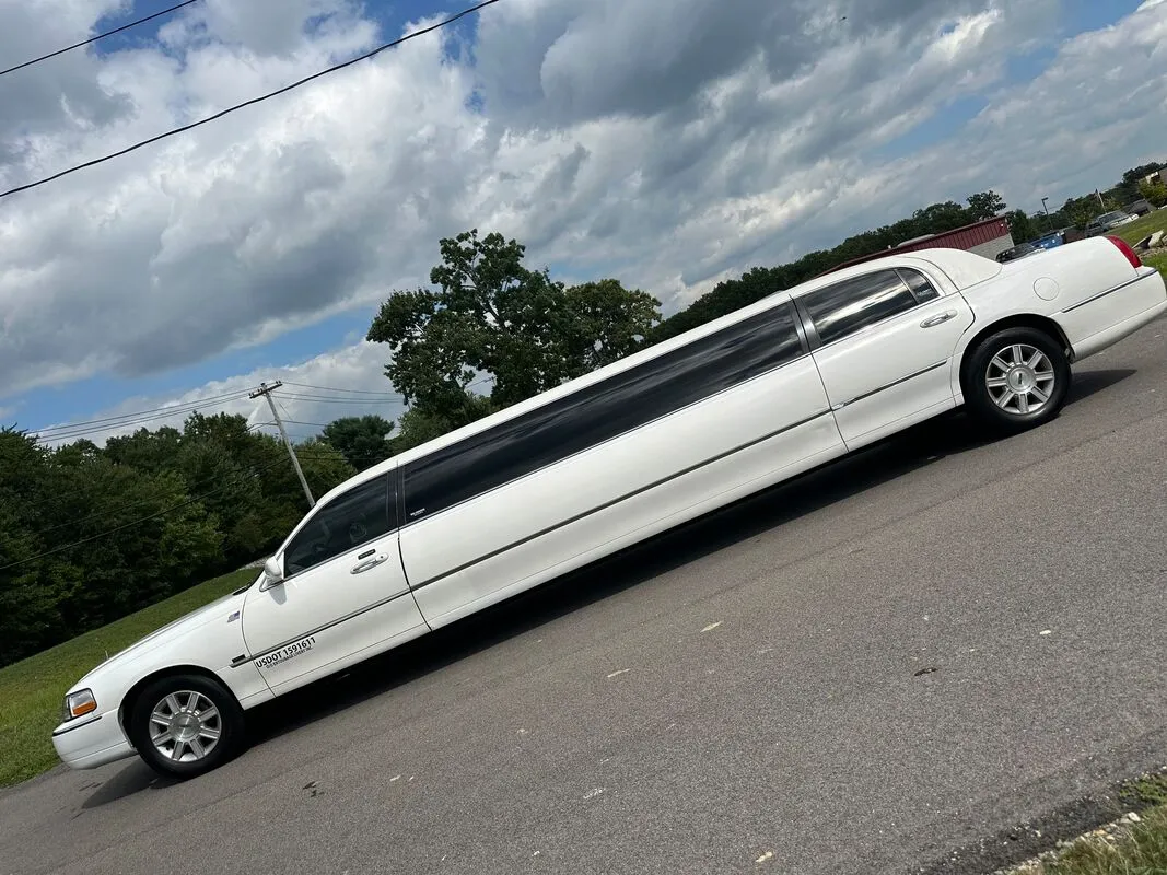 White Lincoln Town CAR Limousine exterior with tinted windows, photo 4 for limo rental in Bennington, VT