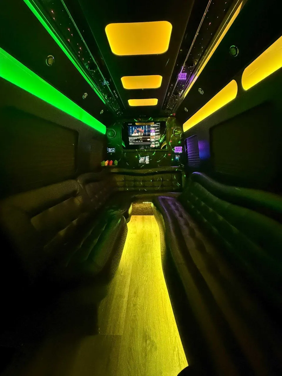 Mercedes Limo Sprinter interior with perimeter lounge seating, LED accent lighting and LED ceiling lighting for party bus rental