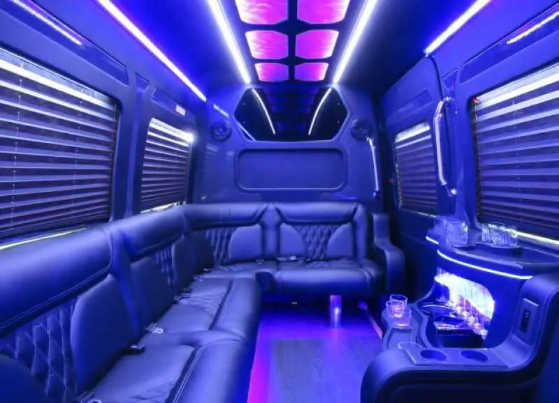 Mercedes Limo Sprinter interior with perimeter lounge seating, window shades and LED accent lighting for party bus rental in Marin County, CA