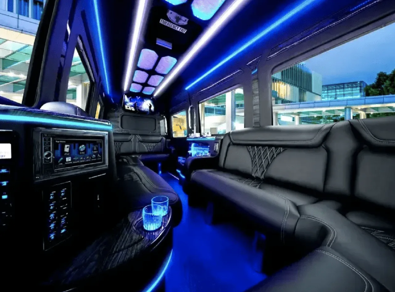 Mercedes Limo Sprinter interior with sofa-style seating, LED accent lighting and LED ceiling lighting for party bus rental in Madera County, CA Mercedes Limo Sprinter interior with sofa-style seating, LED accent lighting and LED ceiling lighting for party bus rental in Madera County, CA