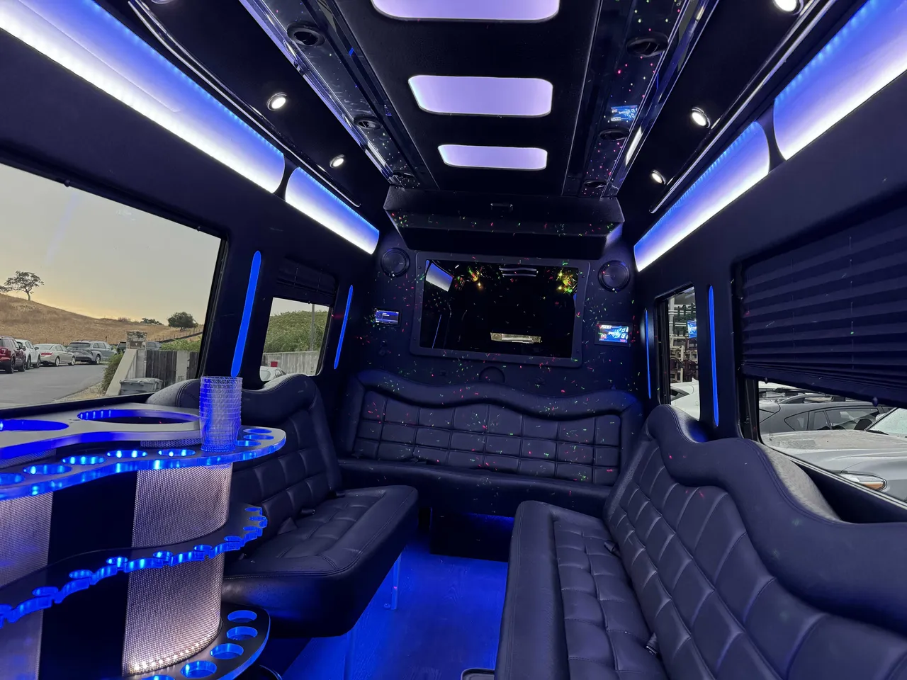 Mercedes Party Bus interior with perimeter lounge seating, window shades and LED accent lighting, photo 5 for party bus rental in Alameda County, CA
