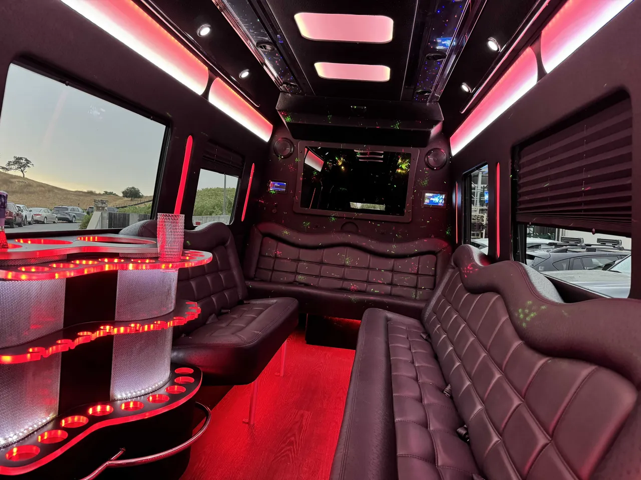 Mercedes Party Bus interior with perimeter lounge seating, window shades and LED accent lighting, photo 6 for party bus rental