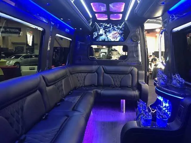 Mercedes Party Bus interior with sofa-style seating, LED accent lighting and LED ceiling lighting for party bus rental in Alameda County, CA