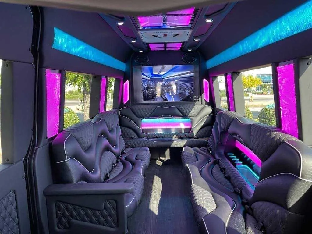 Mercedes Sprinter Limo interior with sofa-style seating, LED accent lighting and LED ceiling lighting for party bus rental in California