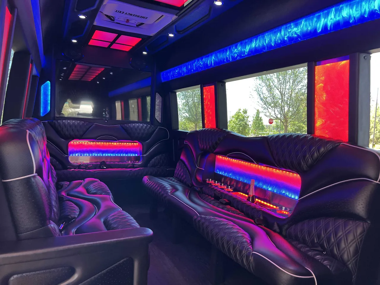 Mercedes Sprinter Limo interior with sofa-style seating, LED accent lighting and LED ceiling lighting, photo 2 for party bus rental in California