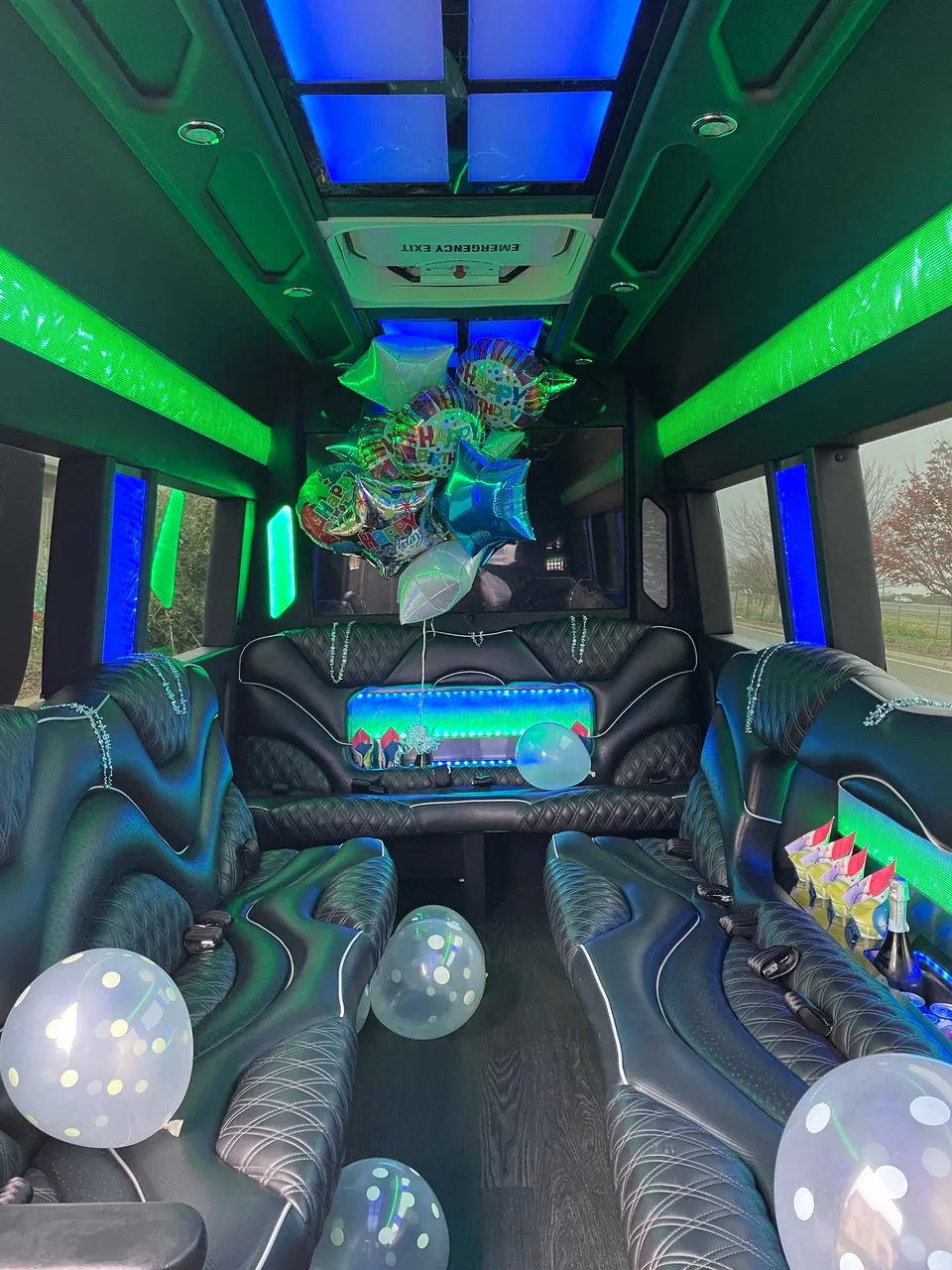 Mercedes Sprinter Limo interior with perimeter lounge seating, LED accent lighting and LED ceiling lighting for party bus rental in California