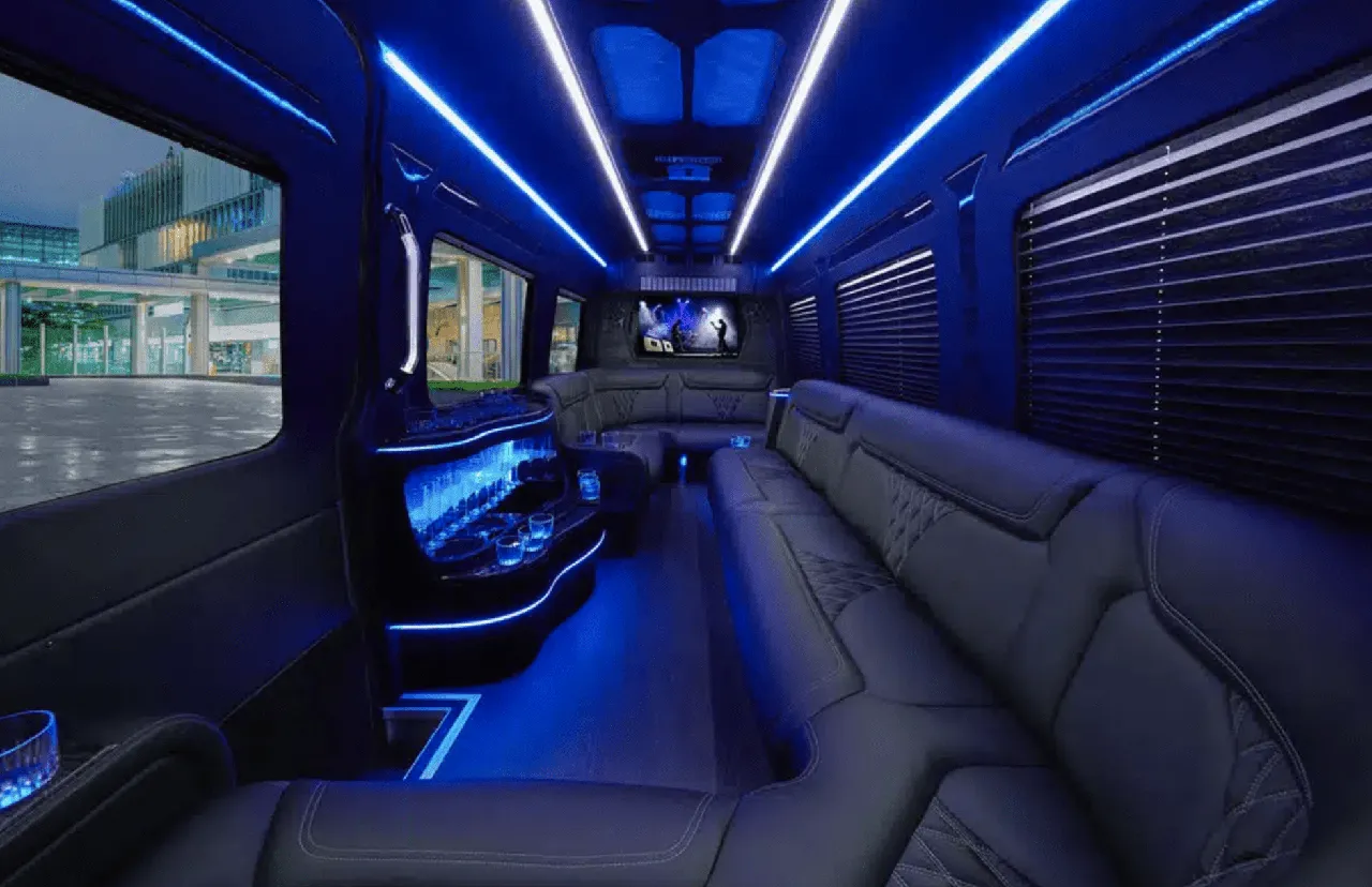 Mercedes Sprinter Limo interior with perimeter lounge seating, window shades and LED accent lighting for party bus rental in Illinois