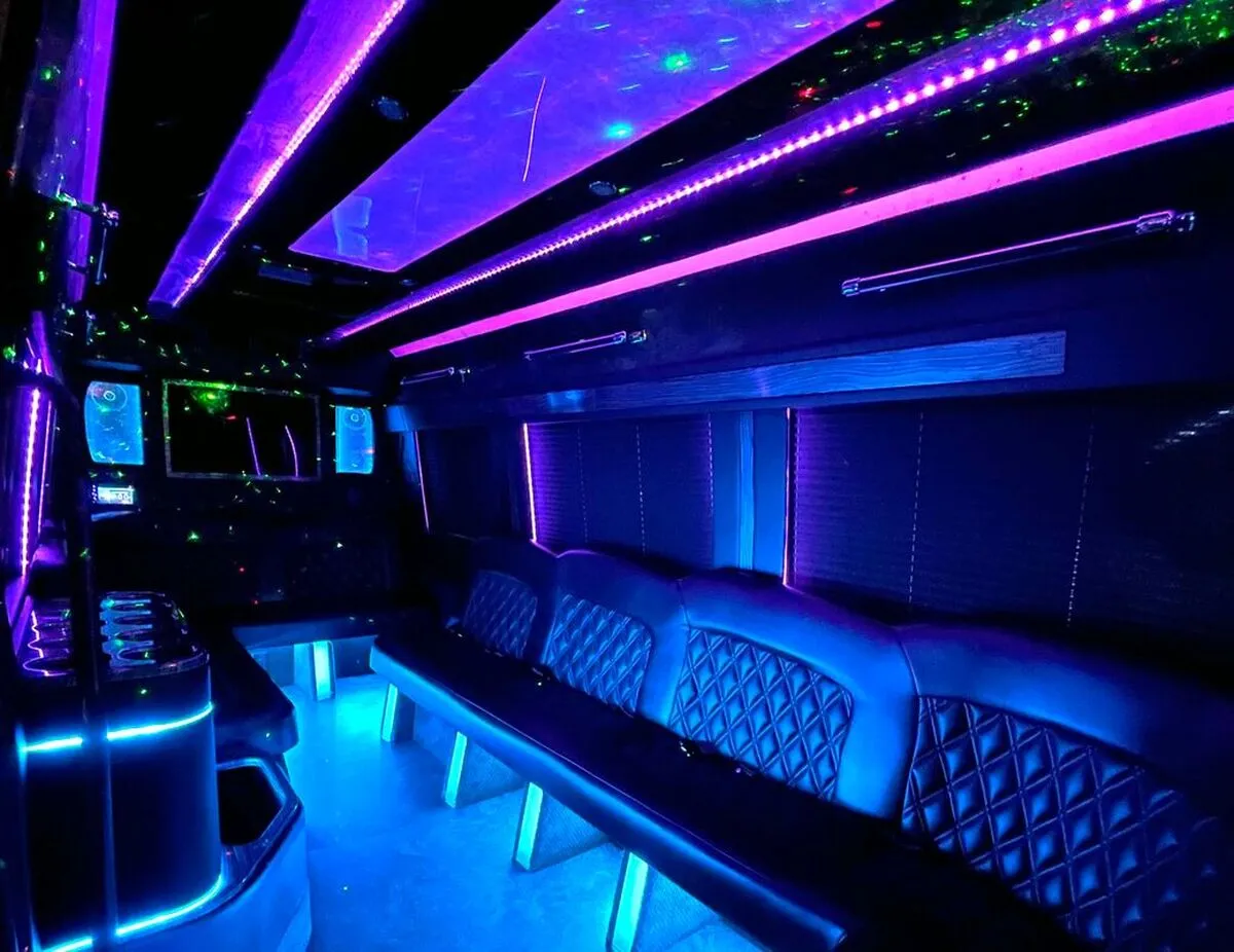 Mercedes-Benz Sprinter XL Mercedes-Benz Sprinter XL interior with perimeter lounge seating, window shades and LED accent lighting for party bus rental