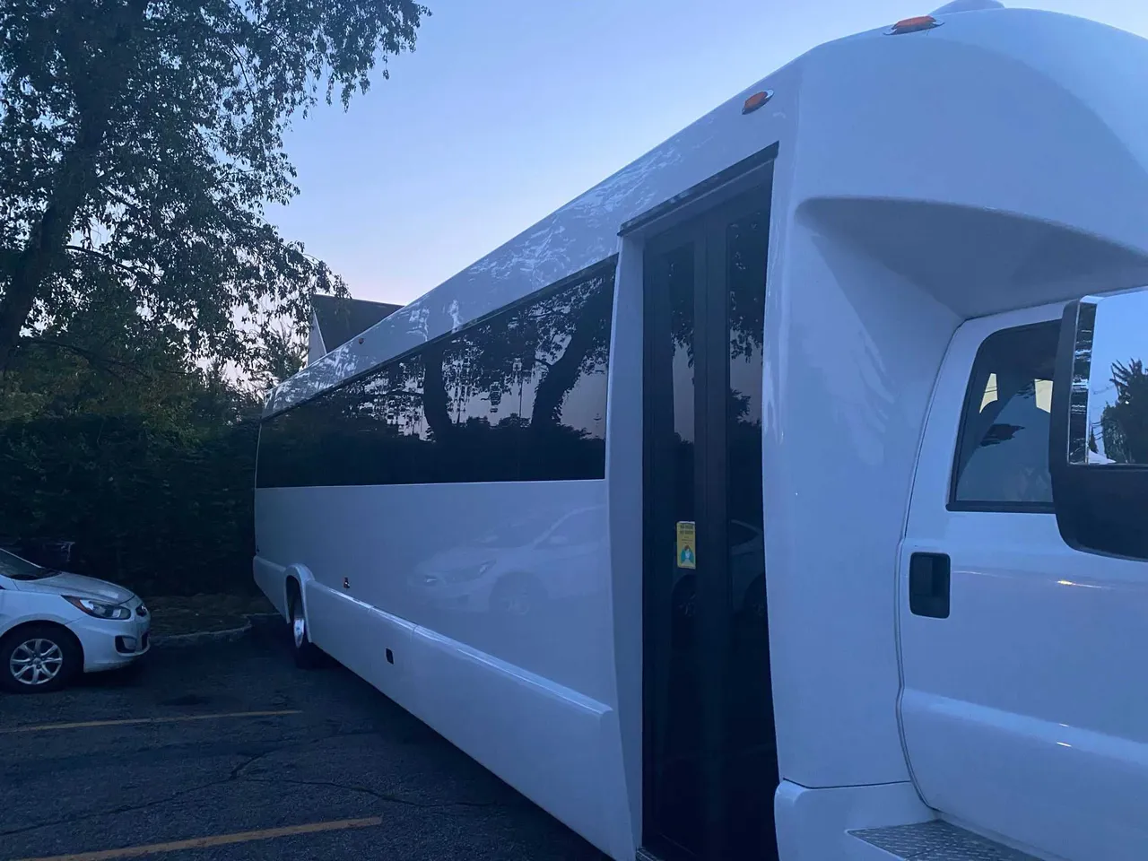 White 25 Passenger Party Bus exterior with tinted windows for party bus rental