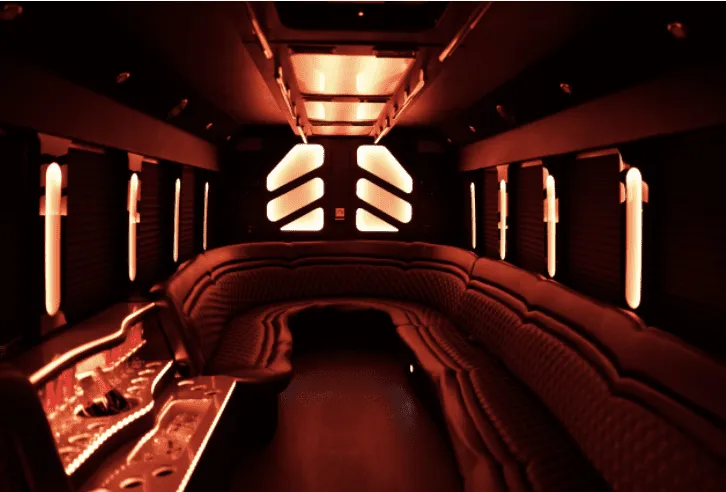 25 Passenger Party Bus interior with perimeter lounge seating and LED accent lighting for party bus rental in Earp, CA