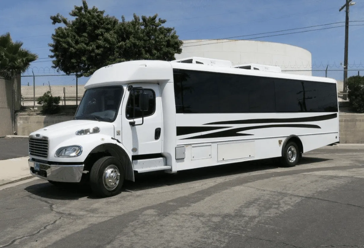 White 26 Passenger Party Bus exterior with tinted windows for party bus rental in Arnold, CA