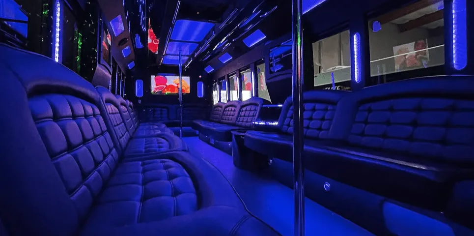 26 Passenger Party Bus interior with perimeter lounge seating, LED accent lighting and LED ceiling lighting for party bus rental in California