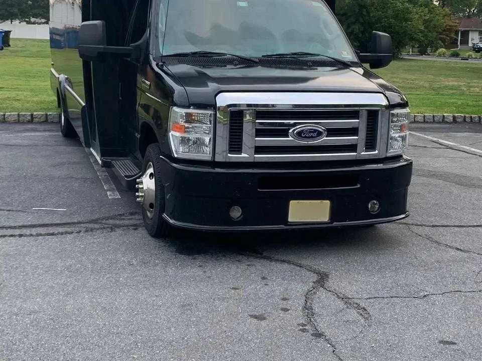 Black 25 Passenger Party Bus offered for party bus rental