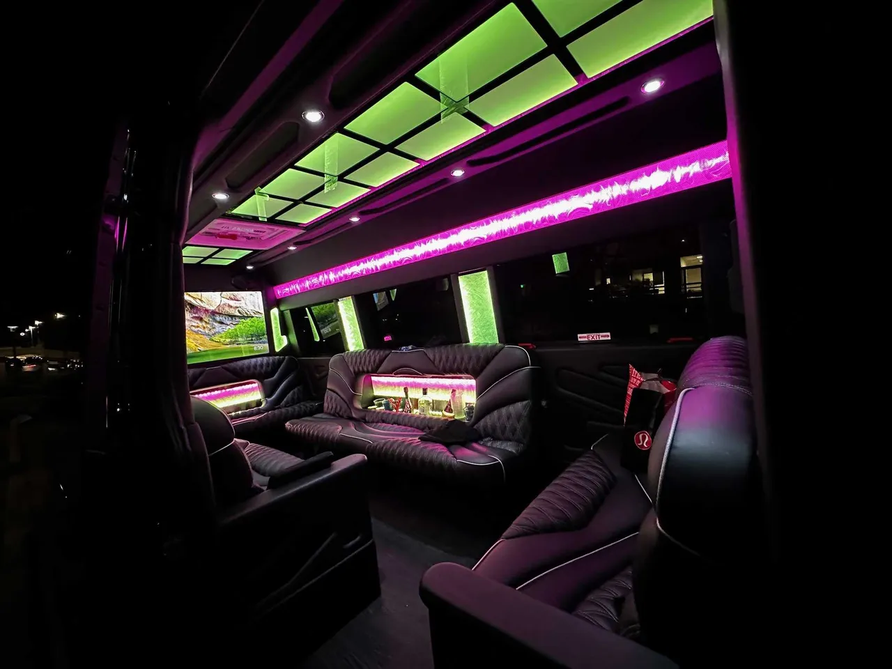 13 Passenger Sprinter Limousine 13 Passenger Sprinter Limousine interior with sofa-style seating, captain's chairs and LED accent lighting for party bus rental